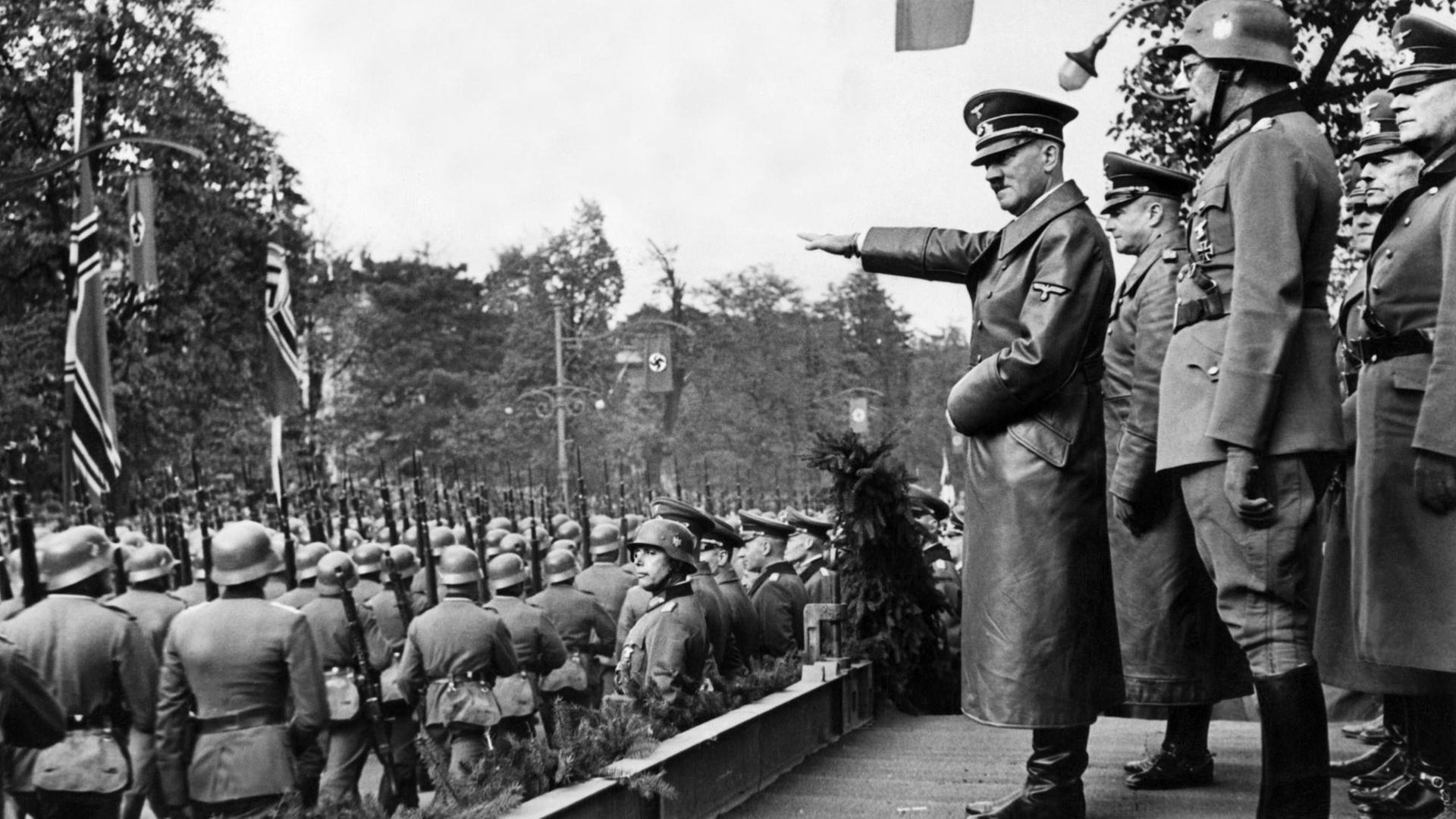 Adolf Hitler grüßt am 5. Oktober 1939 in Warschau, Polen, die vorbeimarschierenden Truppen der Wehrmacht. Hinter dem Diktator stehen (v.l.n.r.) der Oberbefehlshaber des Heeres, Generaloberst Walther von Brauchitsch, der neue Kommandant von Warschau, Generalleutnant Friedrich von Cochenhausen, Generaloberst Gerd von Rundstedt sowie Generaloberst Wilhelm Keitel. Adolf Hitler grüßt am 5. Oktober 1939 in Warschau, Polen, die vorbeimarschierenden Truppen der Wehrmacht. Hinter dem Diktator stehen (v.l.n.r.) der Oberbefehlshaber des Heeres, Generaloberst Walther von Brauchitsch, der neue Kommandant von Warschau, Generalleutnant Friedrich von Cochenhausen, Generaloberst Gerd von Rundstedt sowie Generaloberst Wilhelm Keitel.
