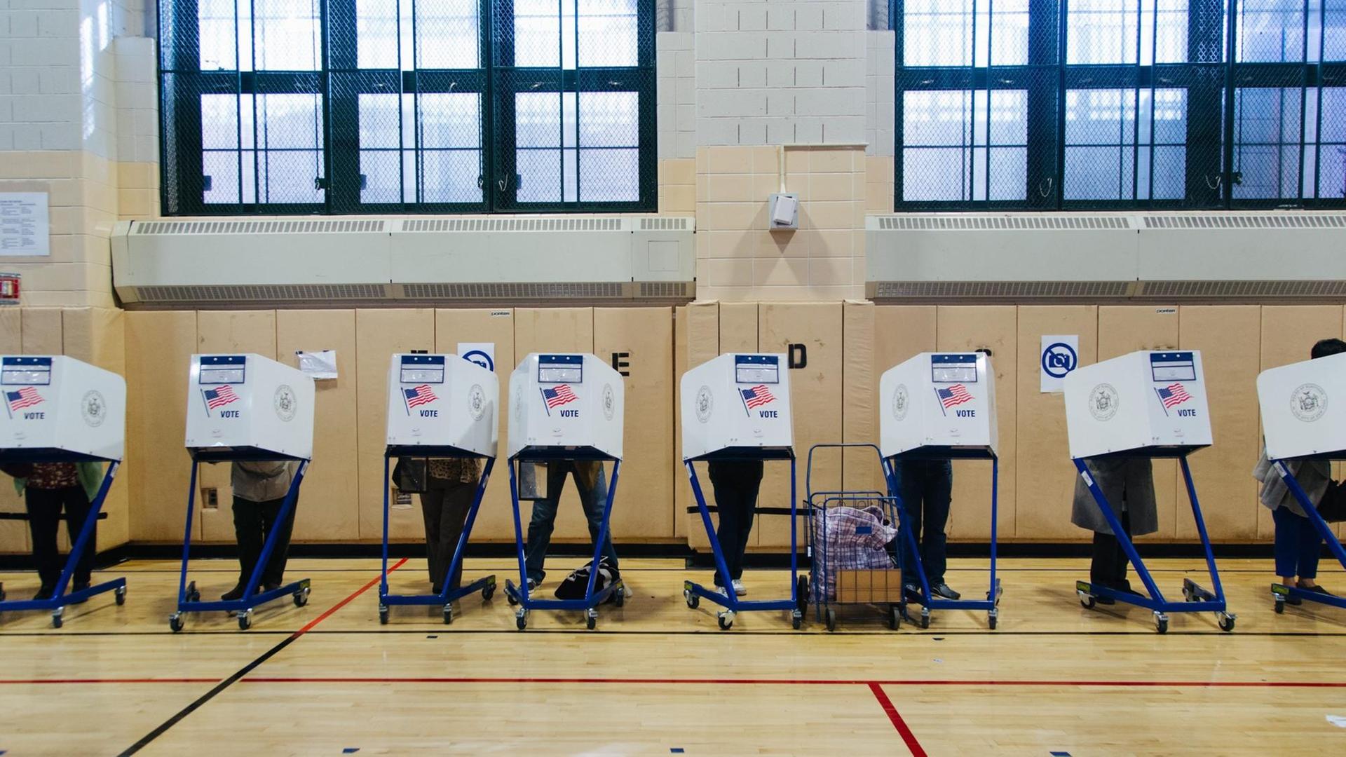 Wähler geben in einem Wahllokal in New York ihre Stimmen an Wahlcomputern ab. Wähler geben in einem Wahllokal in New York ihre Stimmen an Wahlcomputern ab.