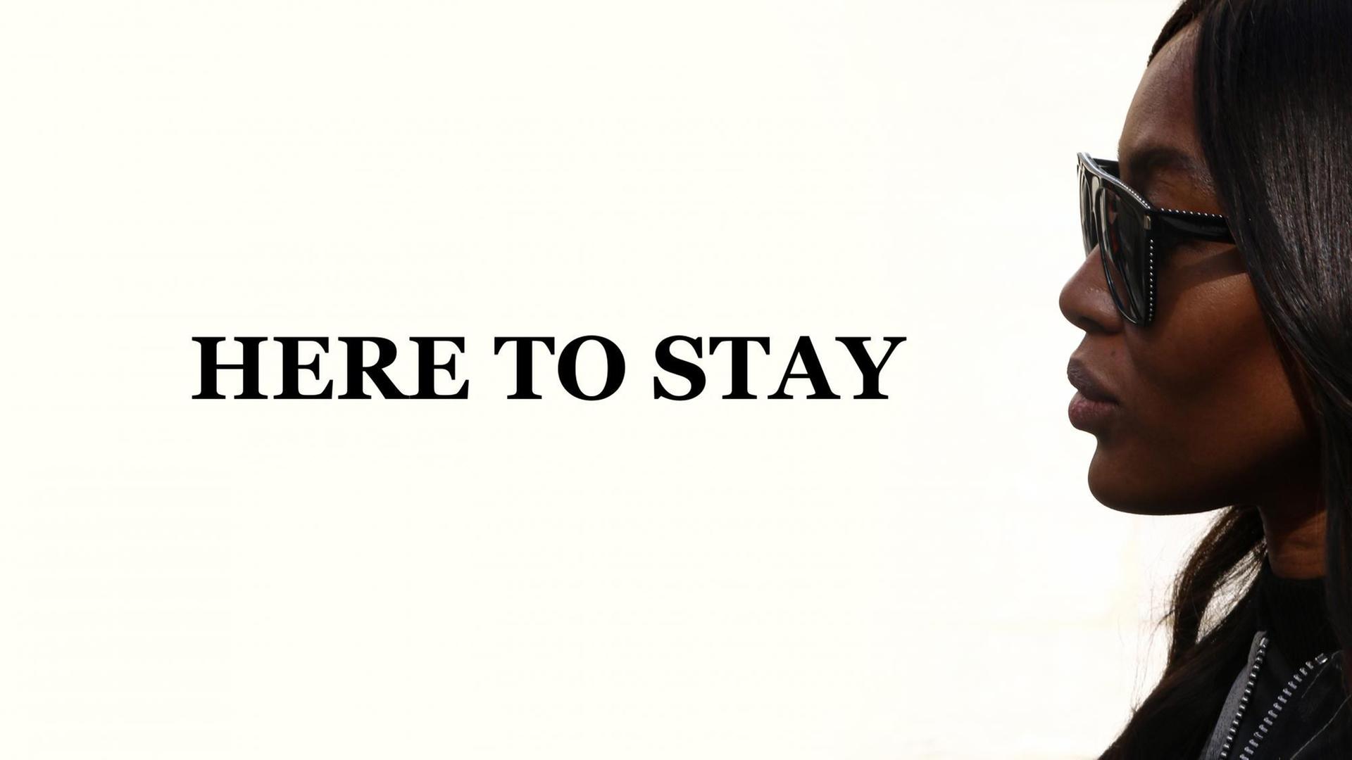 Naomi Campbell im Profil, daneben die Worte "Here to stay". Naomi Campbell im Profil, daneben die Worte "Here to stay".