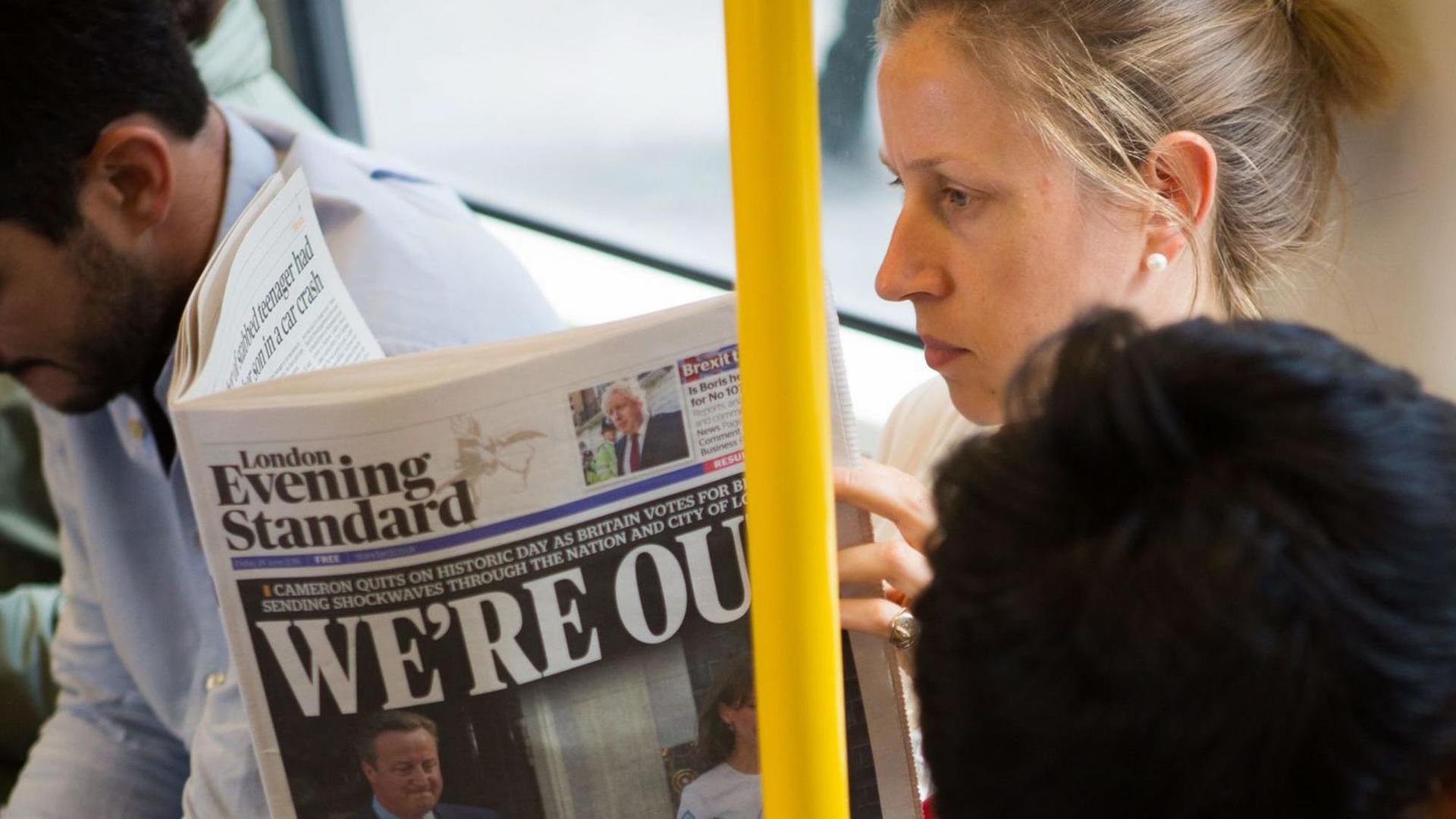 Fahrgäste in der U-Bahn lesen am Tag nach der Brexit-Entscheidung die Zeitungen Fahrgäste in der U-Bahn lesen am Tag nach der Brexit-Entscheidung die Zeitungen