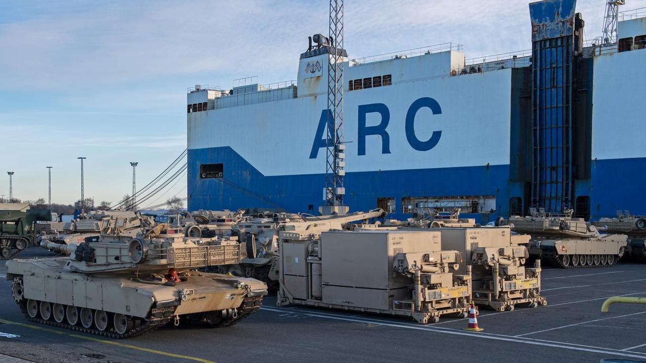 Vor dem Schiff stehen Panzer und militärisches Gerät. Vor dem Schiff stehen Panzer und militärisches Gerät.
