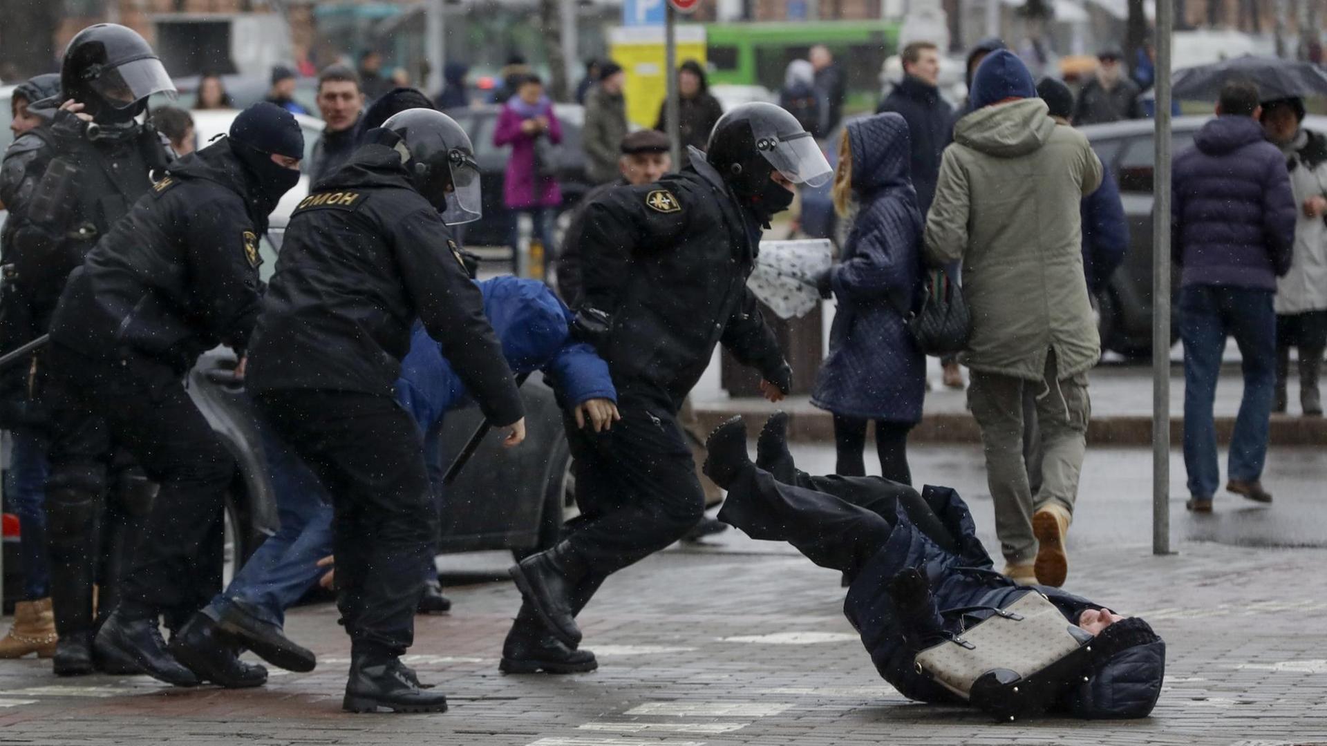 Polizisten stoßen am 25.03.2017 in Minsk (Weißrussland) auf einer Demonstration eine Teilnehmerin um. Polizisten stoßen am 25.03.2017 in Minsk (Weißrussland) auf einer Demonstration eine Teilnehmerin um.