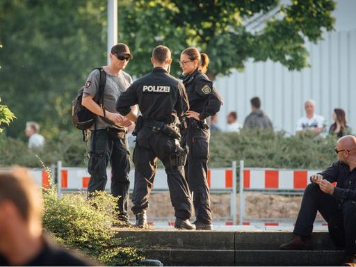 Polizisten bei einer Kontrollen auf dem Parkplatz vor dem ehemaligen Baumarkt in Heidenau.