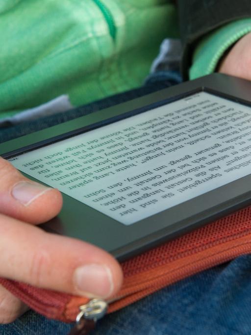 Ein Mann hält am 28.09.2012 in München (Bayern) ein elektronischen Reader der Marke Kindle in seinen Händen.