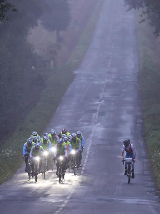 Ein Radteam fährt bei dem 1200km Rennen Paris-Brest-Paris durch den morgendlichen Nebel.