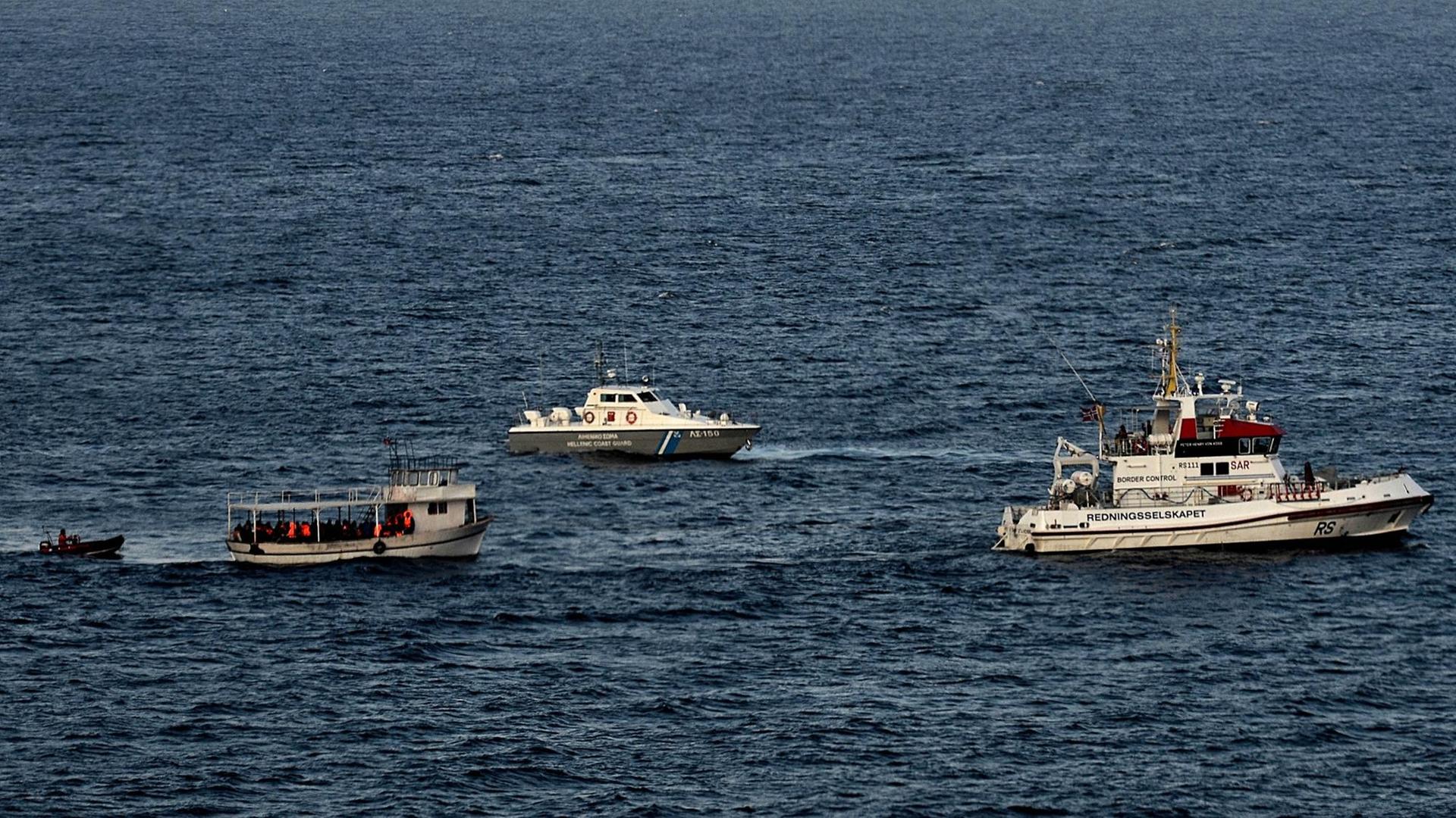 Ein mit Flüchtlingen und Migranten beladenes Boot wird am 7.11.2015 von der griechischen Küstenwache und einem FRONTEX-Boot vor der Küste der griechischen Insel Lesbos eskortiert.