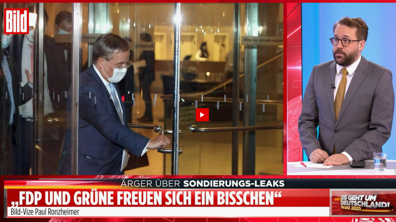 "Bild"-Vize-Chef steht im Studio, auf einem Bildschirm im Hintergrund ein Bild von Armin Laschet und der Schriftzug "Ärger über Sondierung-Leaks" "Bild"-Vize-Chef steht im Studio, auf einem Bildschirm im Hintergrund ein Bild von Armin Laschet und der Schriftzug "Ärger über Sondierung-Leaks"