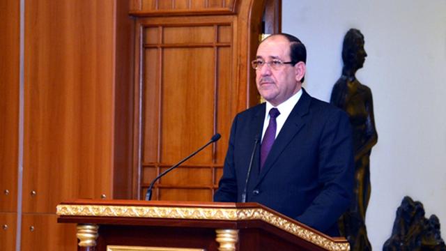 Der irakische Ministerpräsident Nuri al-Maliki steht hinter einem Rednerpult.