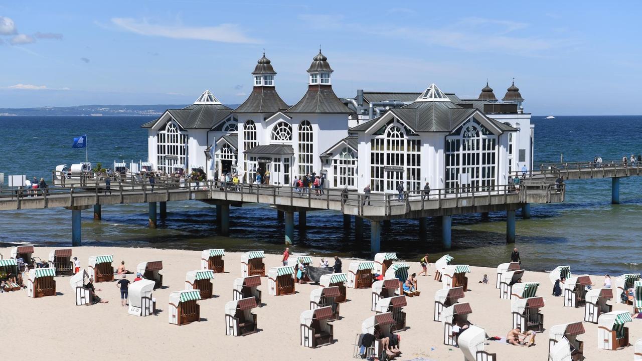 Am Ostseestrand von Sellin auf Rügen haben sich Badegäste in den Strandkörben niedergelassen. Am Ostseestrand von Sellin auf Rügen haben sich Badegäste in den Strandkörben niedergelassen.