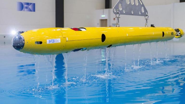 Der Tauchroboter des IceShuttles beim Wassern in der Maritimen Explorationshalle des Deutschen Forschungszentrums für Künstliche Intelligenz (DFKI) / Robotics Innovation Center (RIC) in Bremen Der Tauchroboter des IceShuttles beim Wassern in der Maritimen Explorationshalle des Deutschen Forschungszentrums für Künstliche Intelligenz (DFKI) / Robotics Innovation Center (RIC) in Bremen