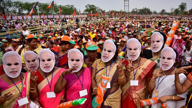 Supporter of India's ruling Bharatiya Janata Party (BJP) wearing masks of Prime Minister Narendra Modi attend an election campaign rally addressed by Modi at Moran town in the northeastern state of Assam, India, March 30, 2019. REUTERS/Anuwar Hazarika