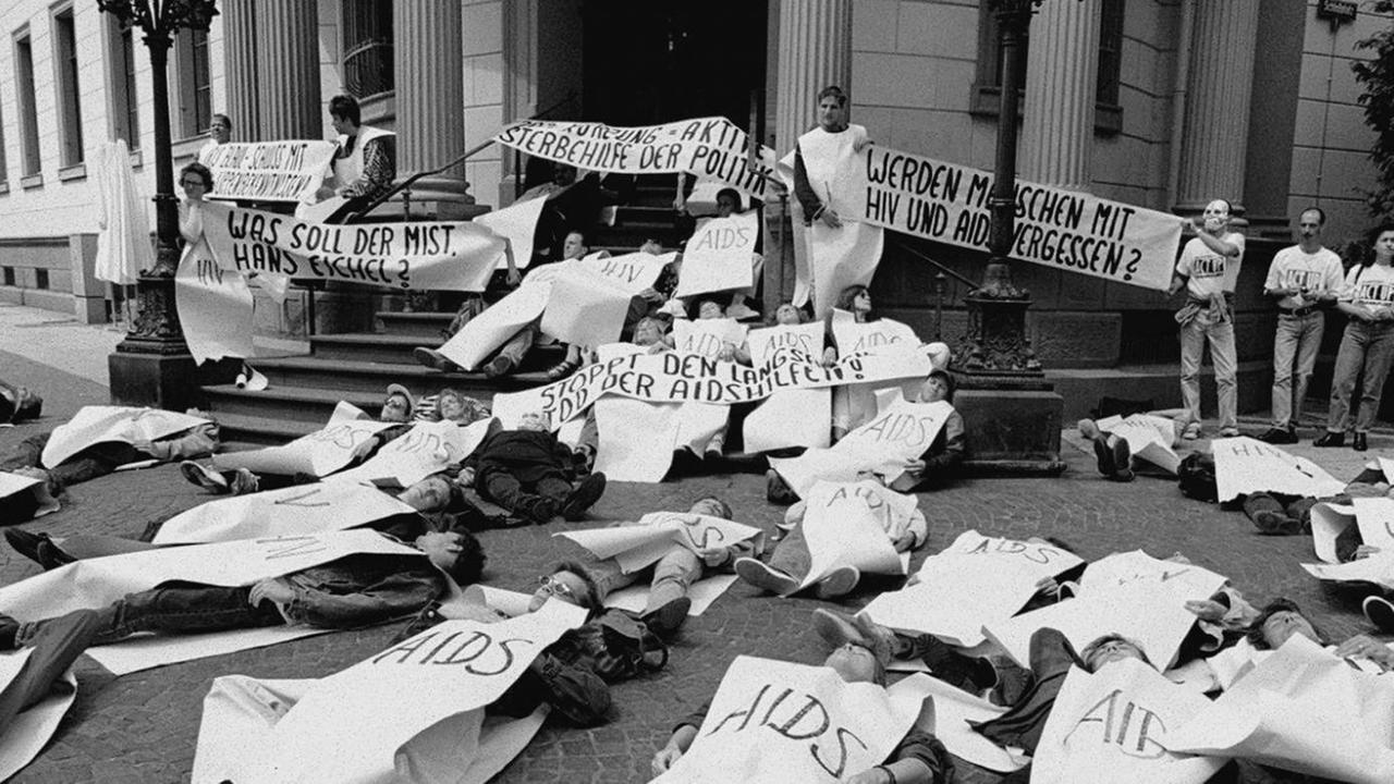 Mitarbeiter und Mitarbeiterinnen der Aids-Hilfen und Mitglieder der Frankfurter Organisation "Act Up" blockieren den Eingang des hessischen Landtags in Wiesbaden. Mitarbeiter und Mitarbeiterinnen der Aids-Hilfen und Mitglieder der Frankfurter Organisation "Act Up" blockieren den Eingang des hessischen Landtags in Wiesbaden.