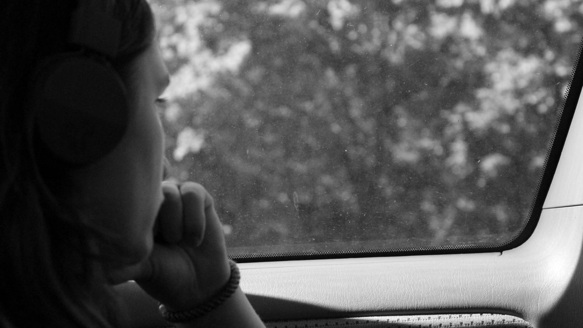 Eine Frau schaut aus dem Fenster. Eine Frau schaut aus dem Fenster.