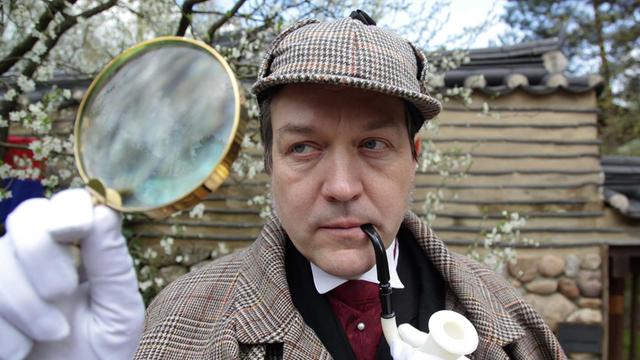 Ein als Sherlock Holmes verkleideter Mann beim Japanisches Kirschblütenfest in den Gärten der Welt in Berlin-Marzahn.