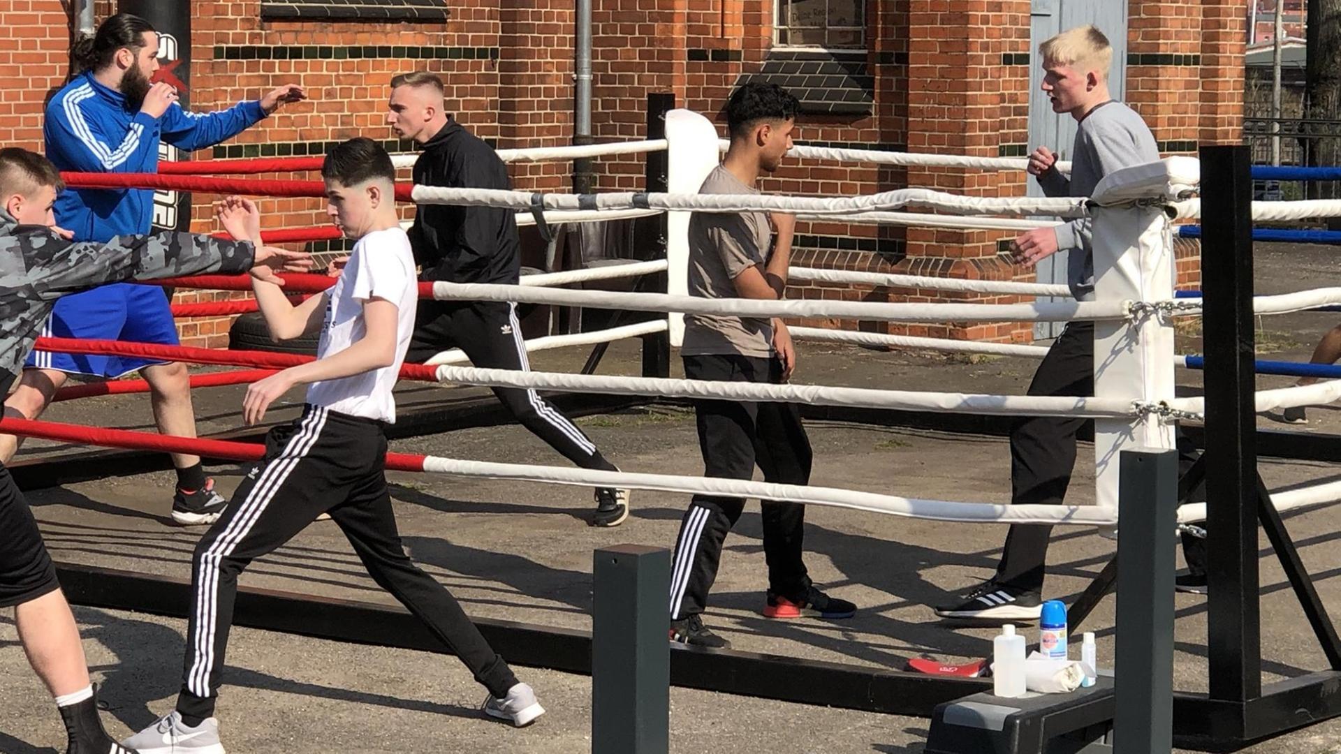 Jugendliche absolvieren ihr Boxtraining beim Boxclub Lübeck draußen auf der Straße in einem mobilen Boxring. Jugendliche absolvieren ihr Boxtraining beim Boxclub Lübeck draußen auf der Straße in einem mobilen Boxring.