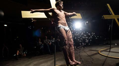 Rouven Stöhr als "Jesus 3" probt am an einem Holzkreuz eine Szene aus dem Stück "Exodus" in der Volksbühne in Berlin; Aufnahme vom 24.3. 2016