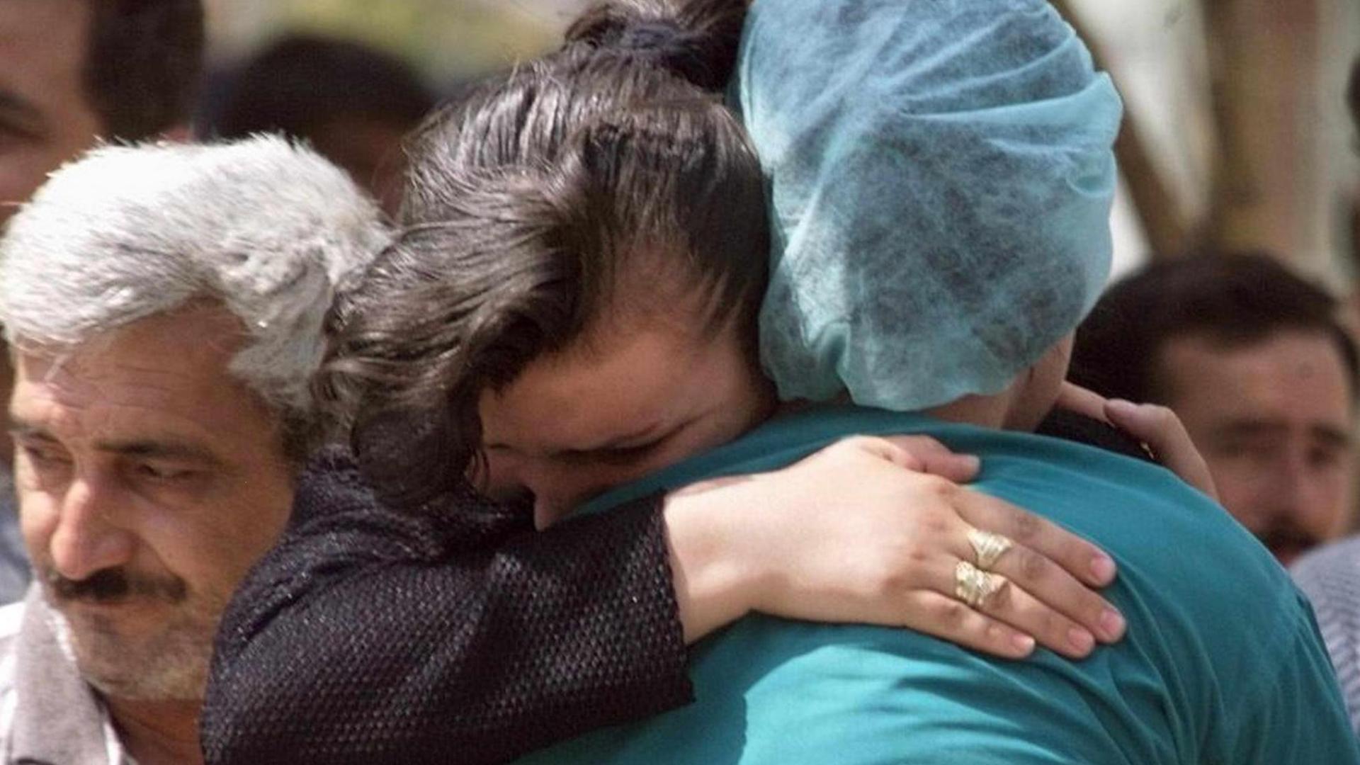 : Sena Bulte (C-L) an earthquake survivor is hugged by a relative 21 August 1999 in Izmit (over 100 kilometers east of Istanbul). Bulte was taken out of the rubbles of her house yesterday. The death toll of the quake stands over 12.000 dead and 33.500 wounded according to figures released today by the Turkish government crisis center. (ELECTRONIC IMAGE) dpa | : Sena Bulte (C-L) an earthquake survivor is hugged by a relative 21 August 1999 in Izmit (over 100 kilometers east of Istanbul). Bulte was taken out of the rubbles of her house yesterday. The death toll of the quake stands over 12.000 dead and 33.500 wounded according to figures released today by the Turkish government crisis center. (ELECTRONIC IMAGE) dpa |