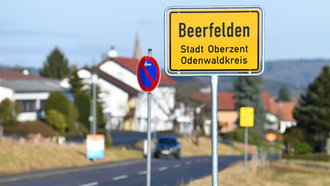 Ein Ortschild mit der Aufschrift "Beerfelden - Stadt Oberzent - Odenwaldkreis" steht am Ortseingang.