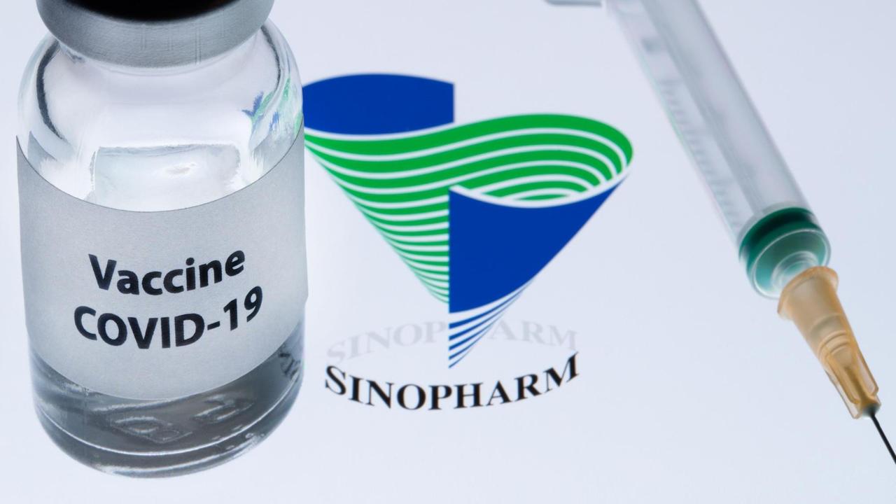 Ein Fläschen mit Corona-Impfstoff, daneben das Logo des chinesischen Unternehmens Sinopharm.