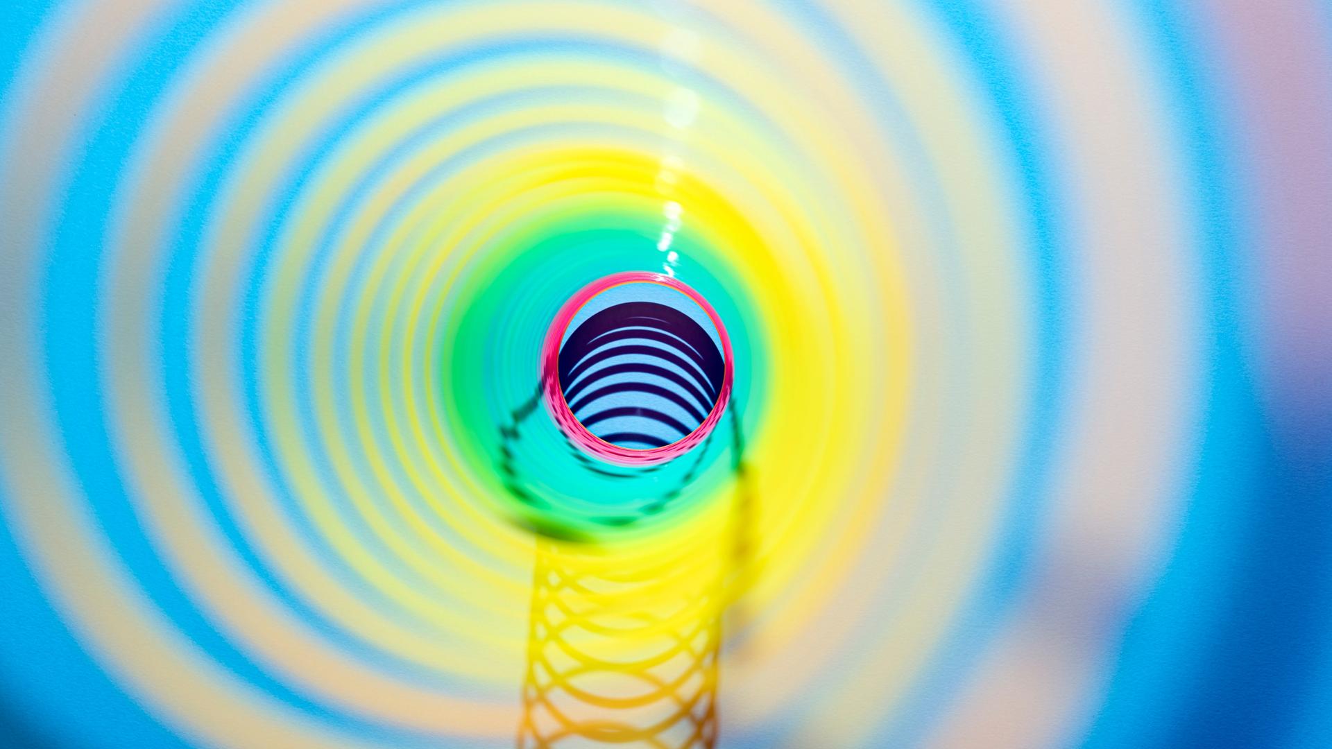 Blick durch ein buntes, spiralförmiges Spielzeug.