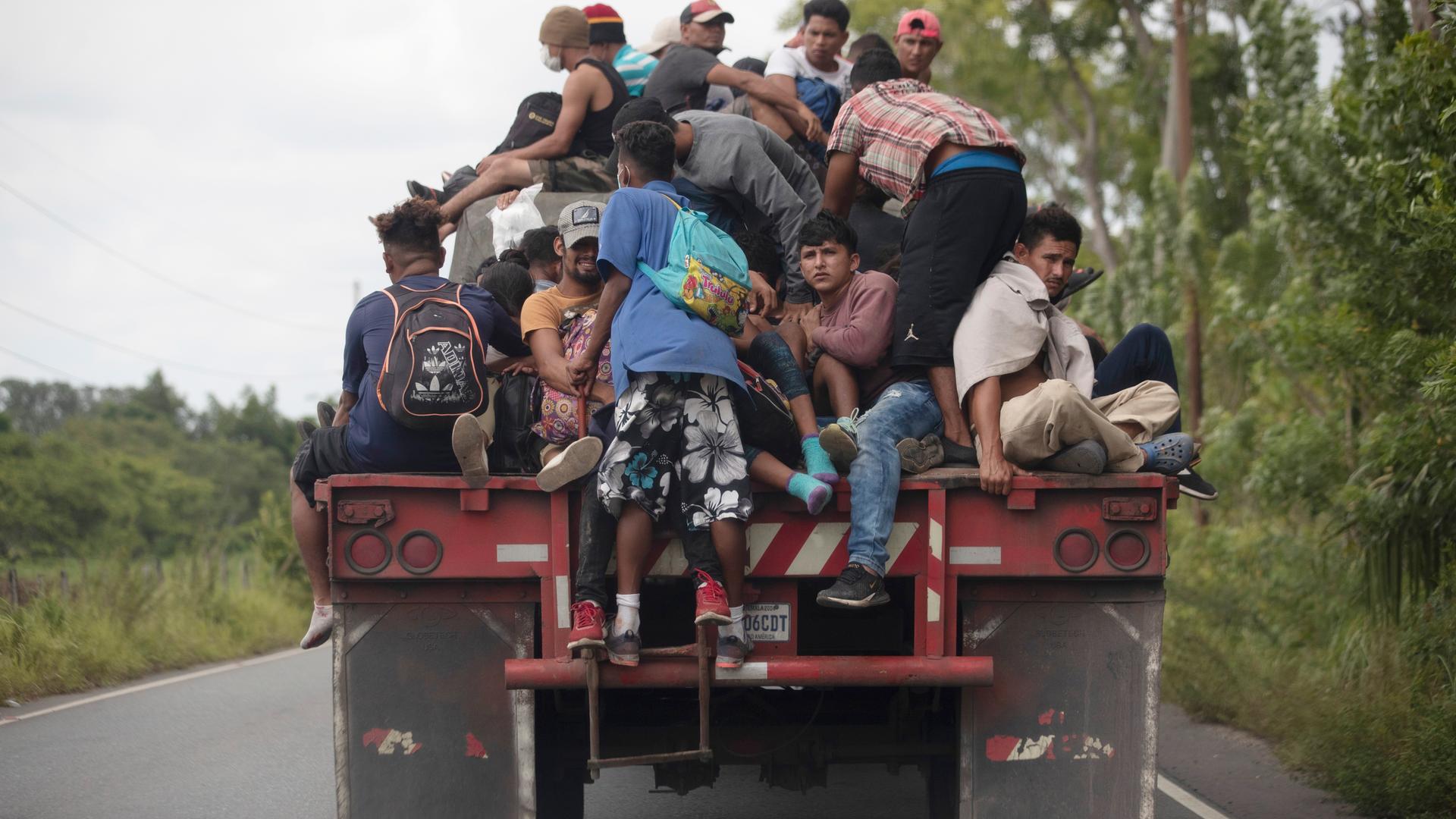Flüchtlinge auf der Ladefläche eines Frachtwagens.