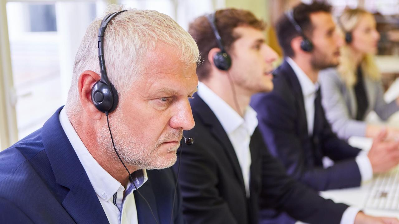 Leute mit Headset bei einer Schulung für Hotline im Callcenter.