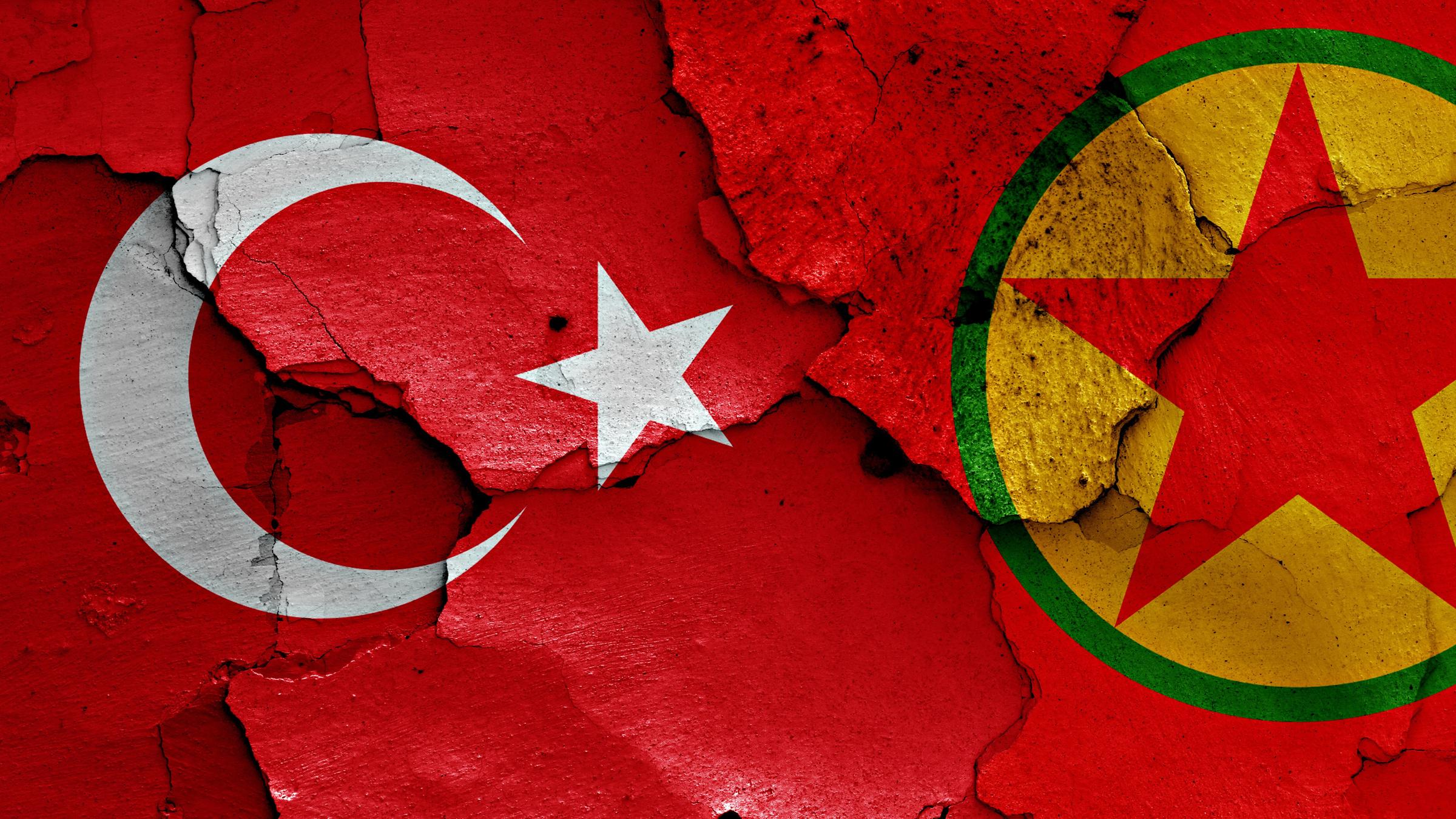 Eine türkische und eine PKK-Flagge auf eine Wand gesprüht