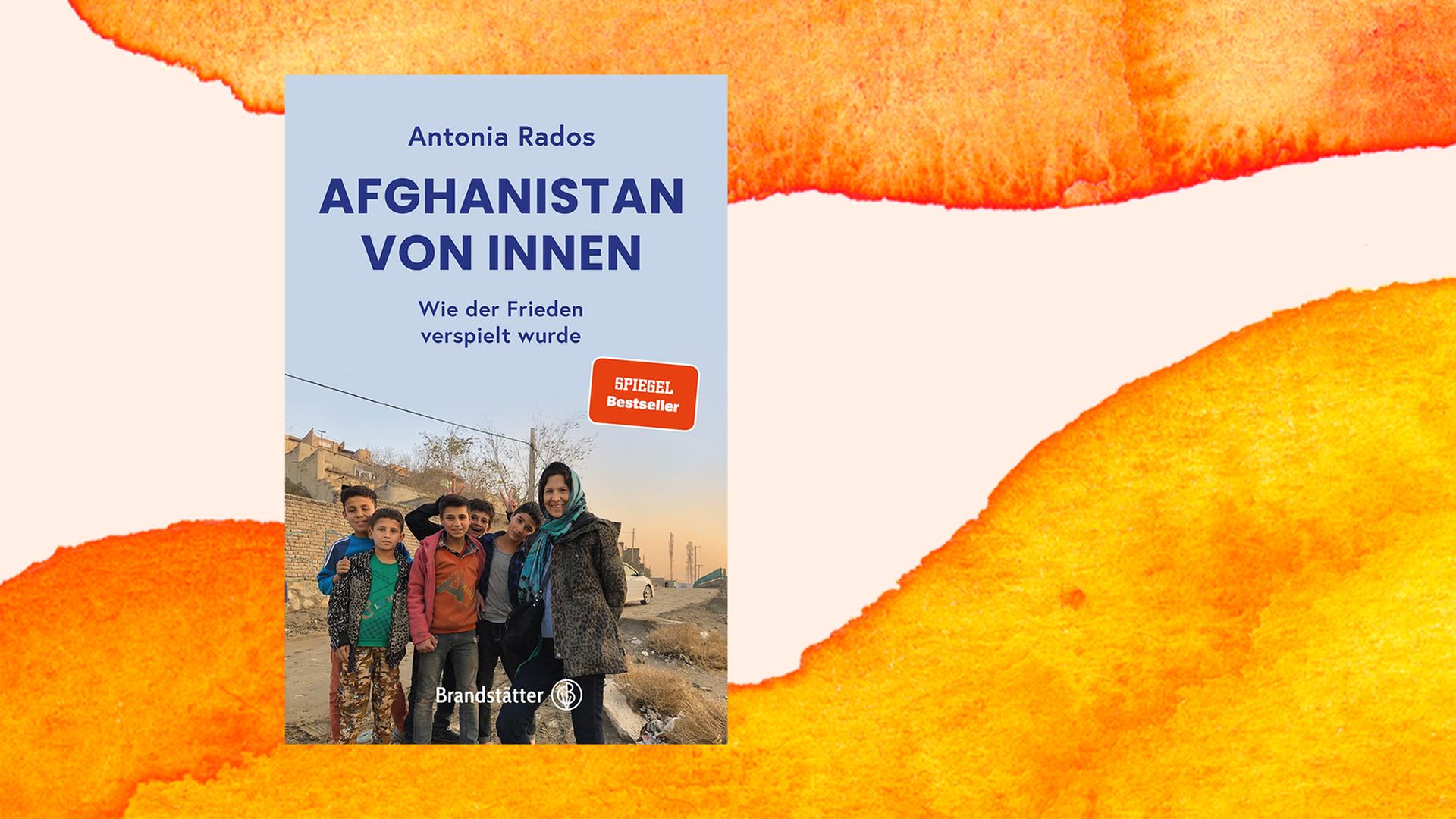 Cover des Buches "Afghanistan von innen" von Antonia Rados vor orangenem Hintergrund. Cover des Buches "Afghanistan von innen" von Antonia Rados vor orangenem Hintergrund.