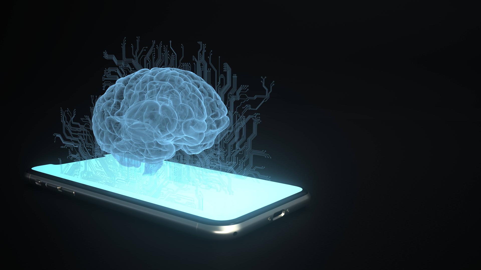 Die Illustration zeigt ein blau leuchtendes Gehirn über einem Smartphone. Die Illustration zeigt ein blau leuchtendes Gehirn über einem Smartphone.