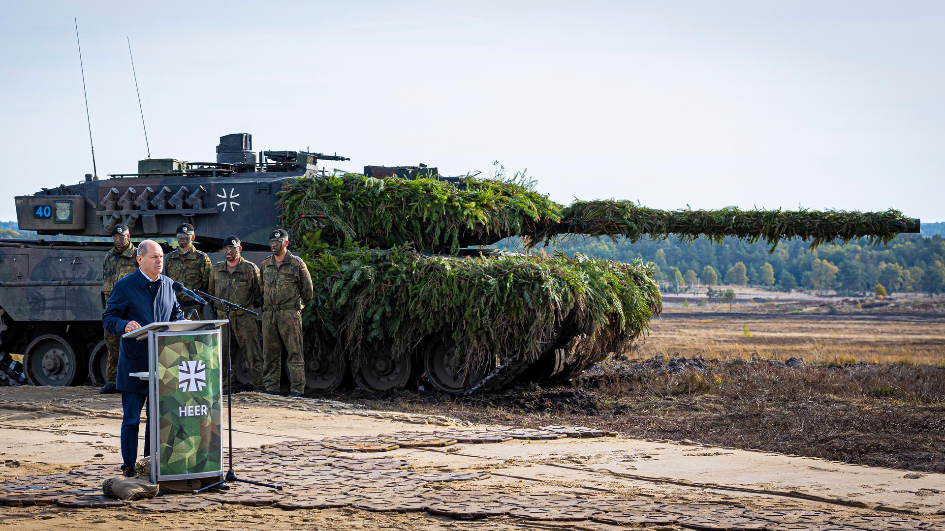 Bundeskanzler Olaf Scholz (SPD) spricht vor einem Kampfpanzer Leopard 2 nach der Ausbildungs- und Lehrübung des Heeres im Landkreis Heidekreis in der Lüneburger Heide zu Soldaten. Bundeskanzler Olaf Scholz (SPD) spricht vor einem Kampfpanzer Leopard 2 nach der Ausbildungs- und Lehrübung des Heeres im Landkreis Heidekreis in der Lüneburger Heide zu Soldaten.