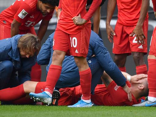 Niklas Süle liegt auf dem Rasen, die Hände vor das Gesicht geschlagen. Er wird medizinisch behandelt.  