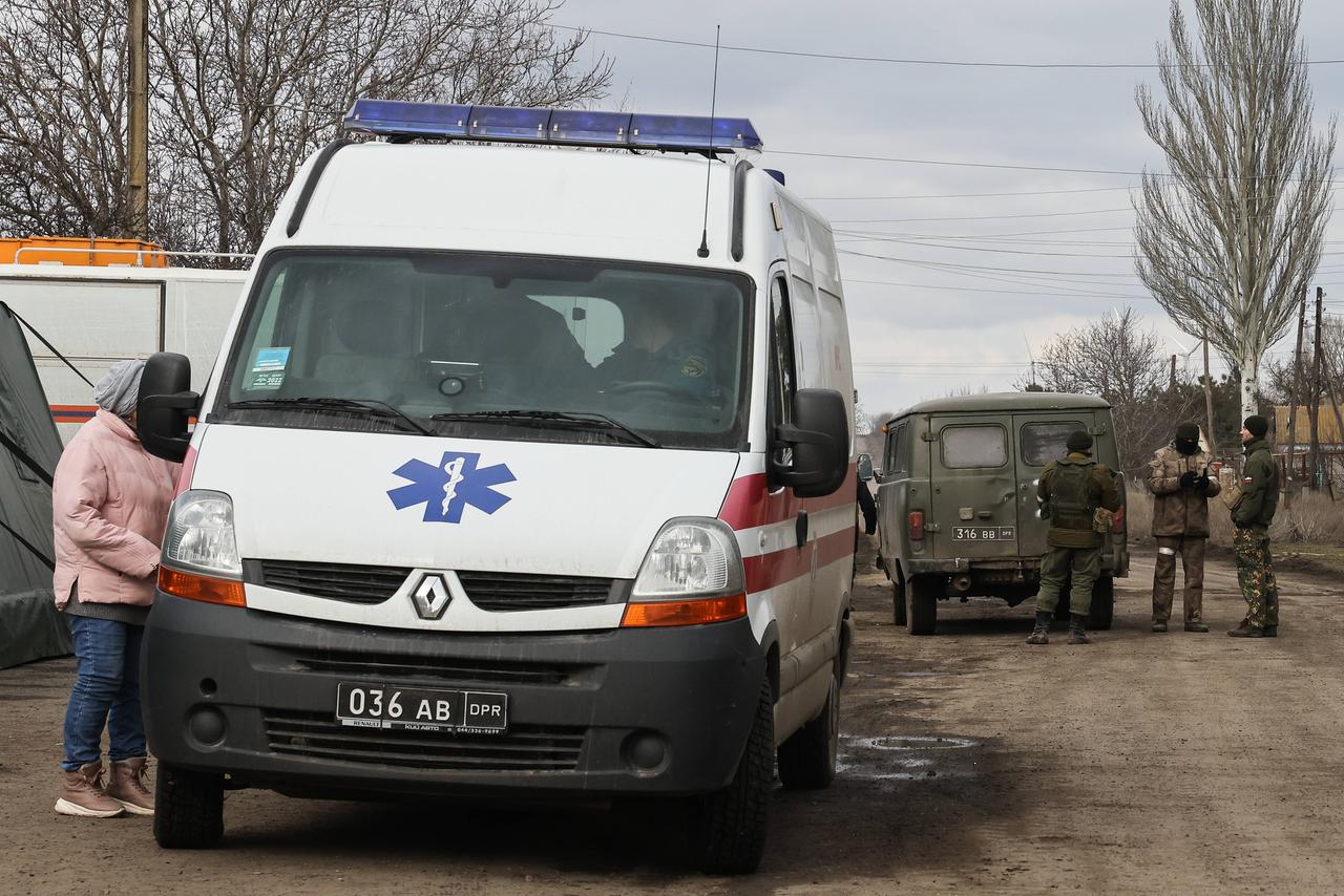 Das Foto der russischen Agentur ITAR-TASS soll Zivilisten und Einsatzkräfte in einem Dorf nahe Mariupol zeigen. Das Foto der russischen Agentur ITAR-TASS soll Zivilisten und Einsatzkräfte in einem Dorf nahe Mariupol zeigen.