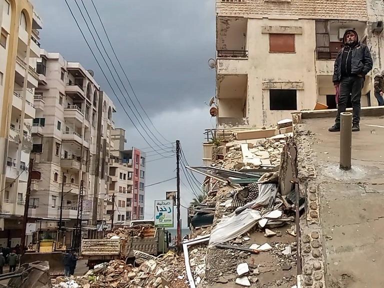 Ein Anwohner steht am 6. Februar 2023 in der syrischen Hafenststadt Latakia nach einem Erdbeben auf den Trümmern eines Hauses. 