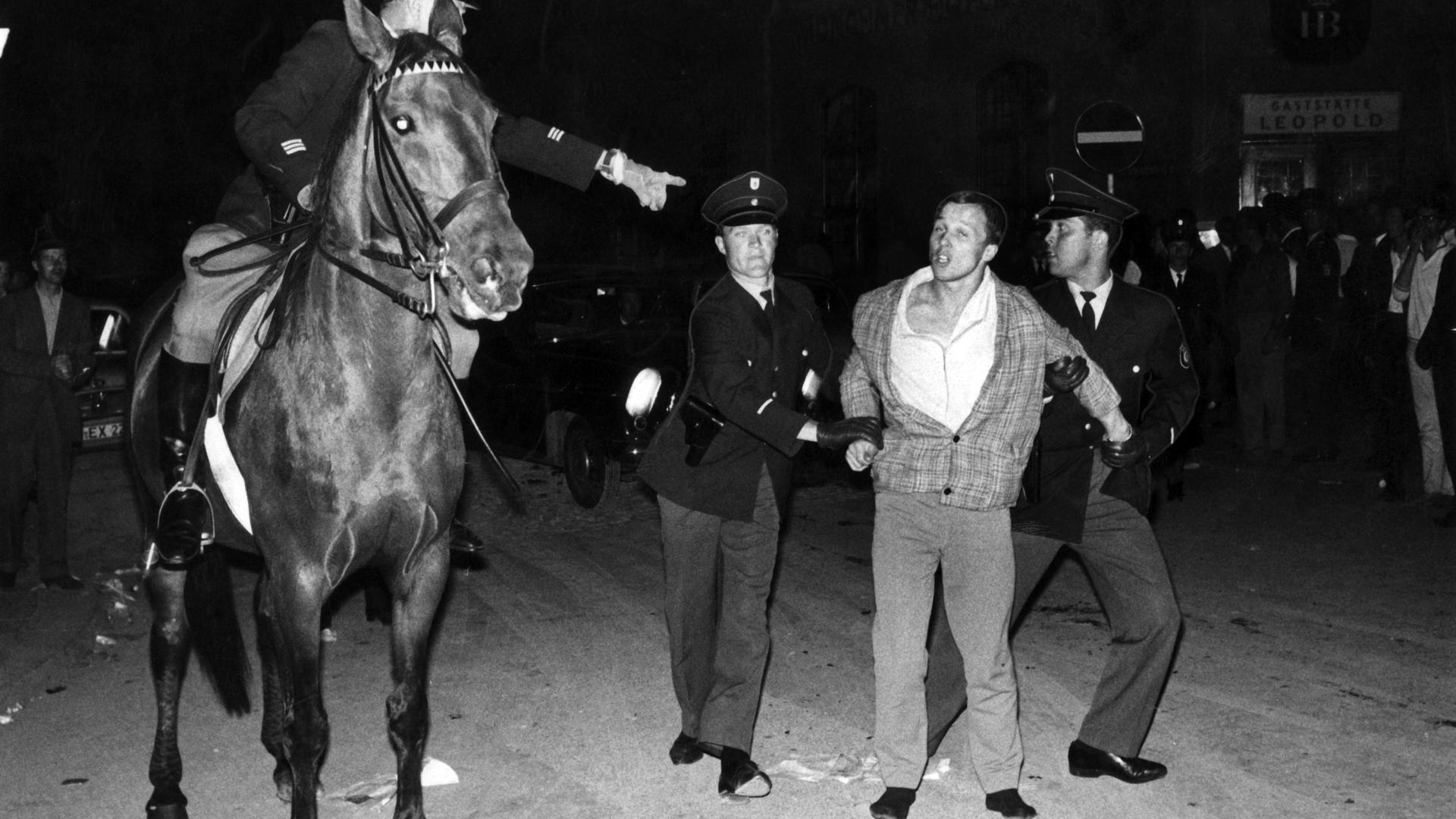 "Schwabinger Krawalle": Polizisten nehmen am 23. Juni 1962 auf der Leopoldstraße in München-Schwabing einen Jugendlichen fest. 
