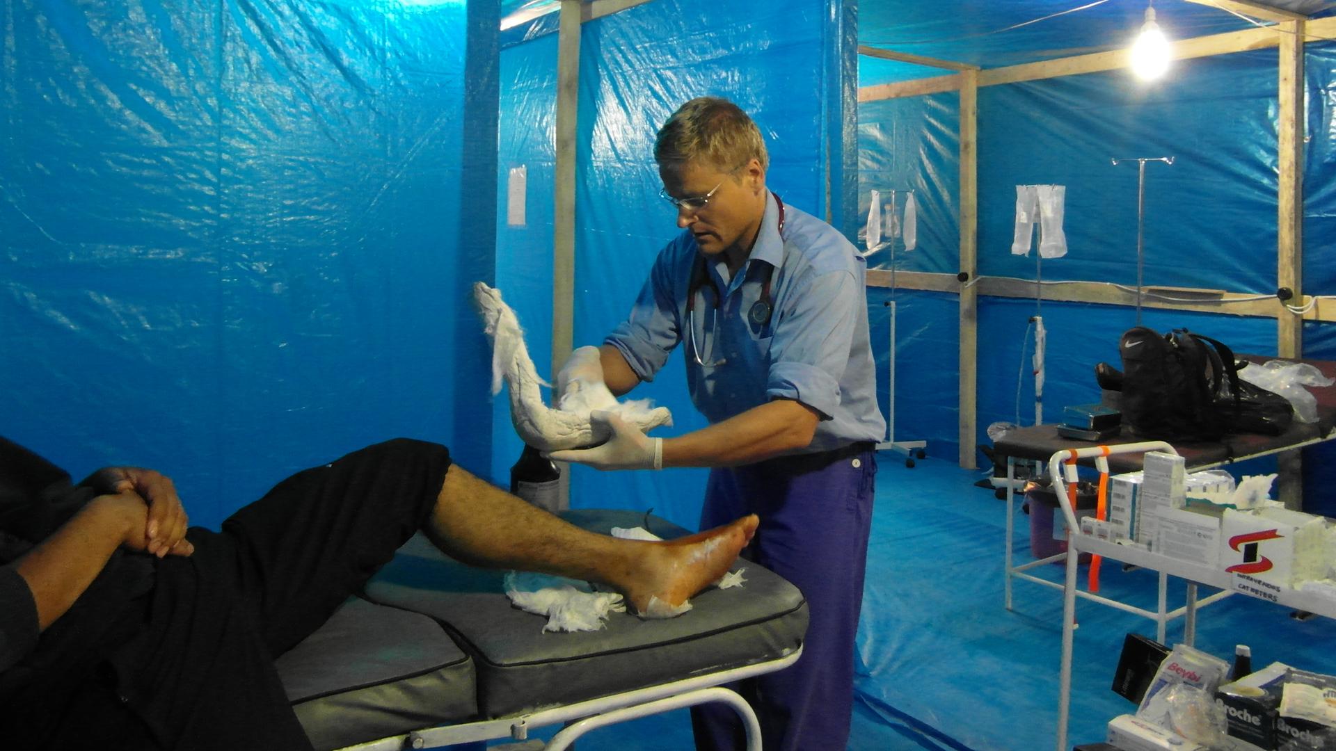 Ein Arzt von "Ärzte ohne Grenzen" behandelt einen Patienten in einem medinizinischen Behelfszelt. 