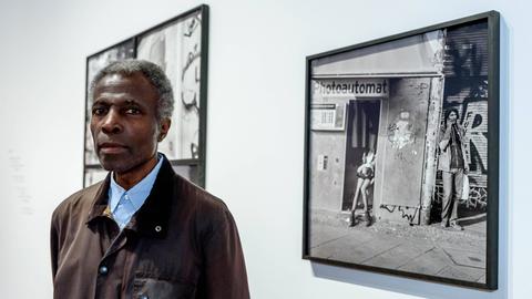 Der Fotograf Akinbode Akinbiyi 2020 bei der Fotoausstellung Six Songs, Swirling Gracefully in the Taut Air im Berliner Gropius Bau, die seine Schwarz-Weiß-Fotografien zeigt.