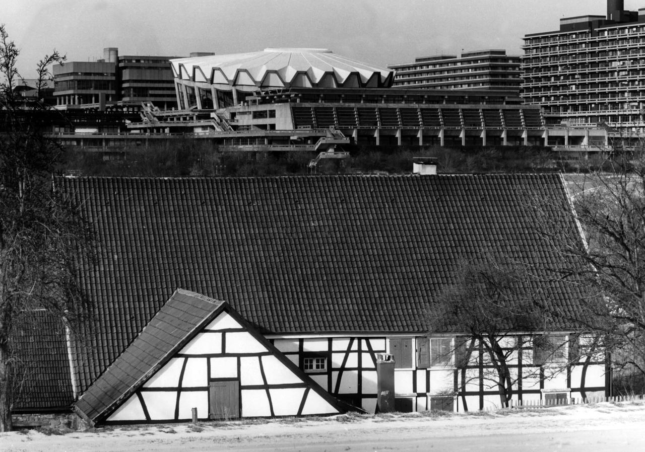 Vorn ein traditionelles Fachwerkhaus, im Hintergrund die Ruhr-Universität mit Auditorium Maximum (Rundbau). Aufnahme aus dem Jahr 1987