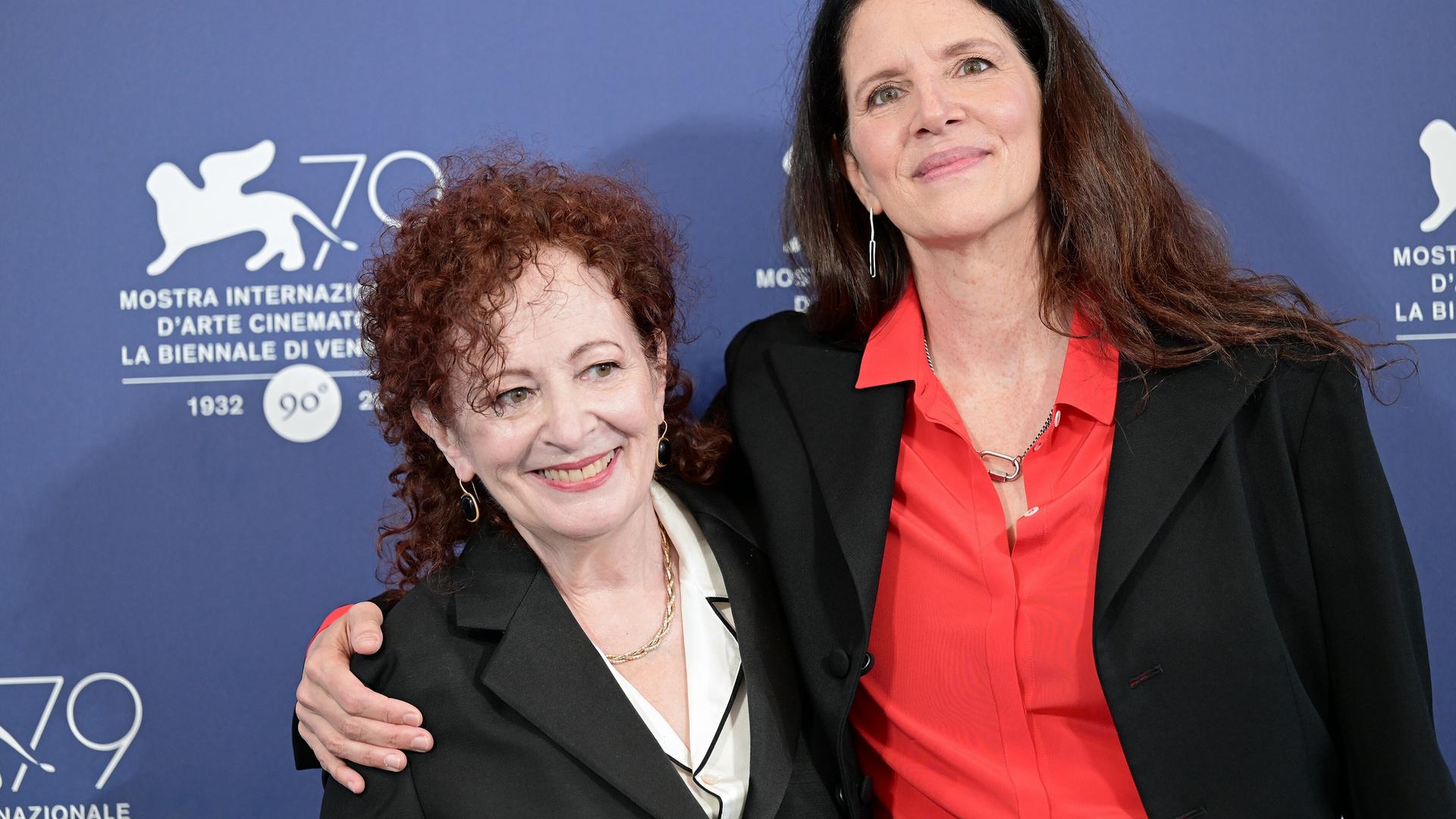 Laura Poitras und Nan Goldin stehen Arm in Arm vor einer Fotowand Laura Poitras und Nan Goldin stehen Arm in Arm vor einer Fotowand