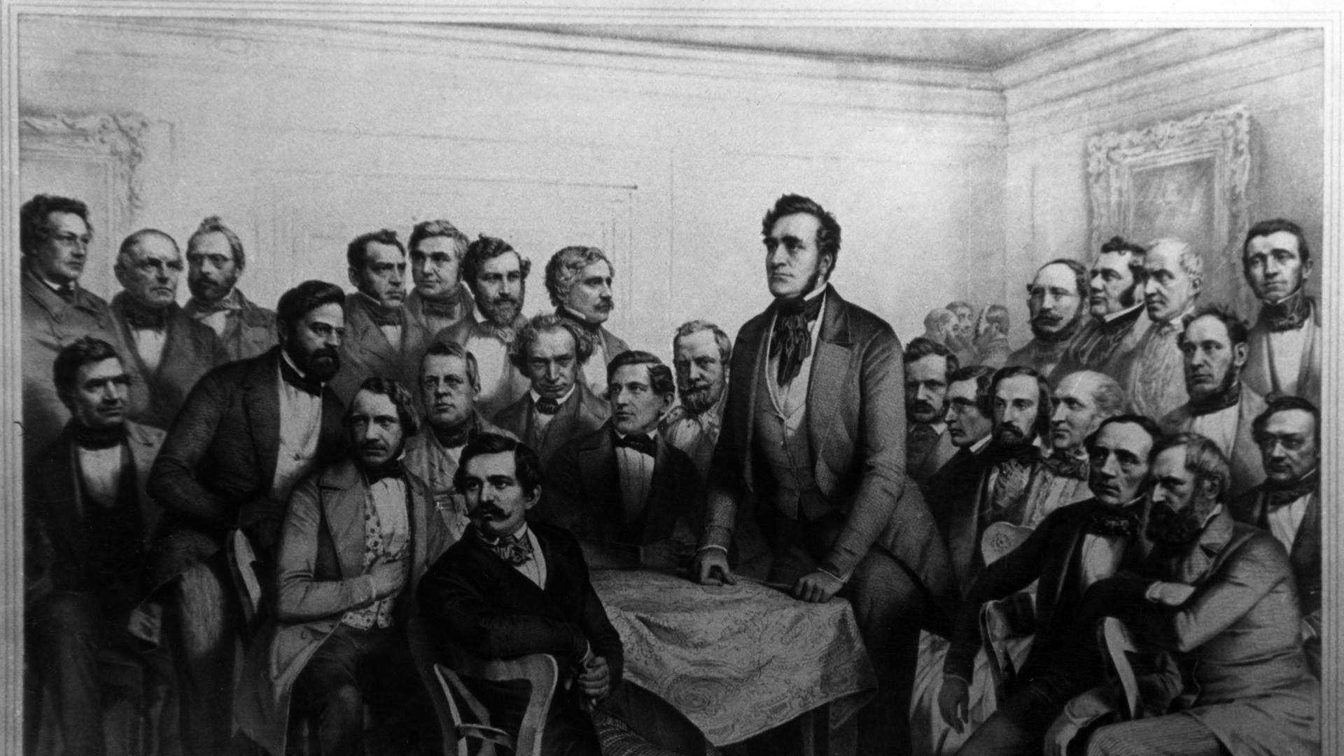 Eine historische scharz-weiß- Zeichnung zeigt den ersten Präsidenten der deutschen Nationalversammlung 1848, Freiherrn Heinrich von Gagern, inmitten der Abgeordneten in Frankfurt am Main. Eine historische scharz-weiß- Zeichnung zeigt den ersten Präsidenten der deutschen Nationalversammlung 1848, Freiherrn Heinrich von Gagern, inmitten der Abgeordneten in Frankfurt am Main.