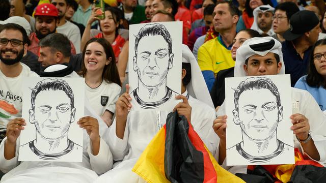 Football fans in the stands hold portraits of German football player Mesut Ozil during the Qatar 2022 World Cup Group E football match between Spain and Germany at the Al-Bayt Stadium in Al Khor, north of Doha on November 27, 2022. Photo by Laurent Zabulon/ABACAPRESS.COM