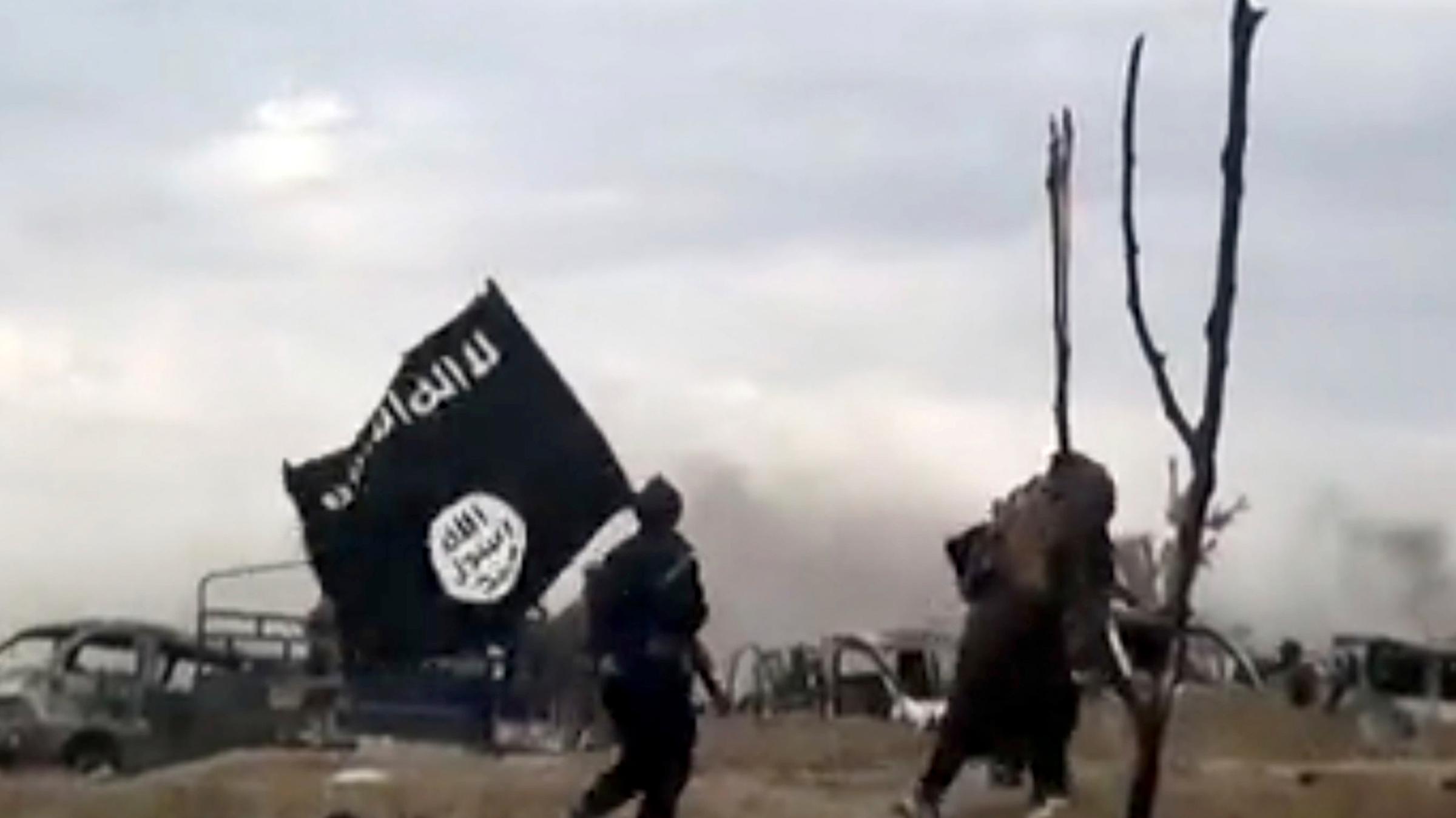 Das unscharfe Bild zeigt zwei IS-Kämpfer, die über einen Sandhaufel lau...</p>

                        <a href=