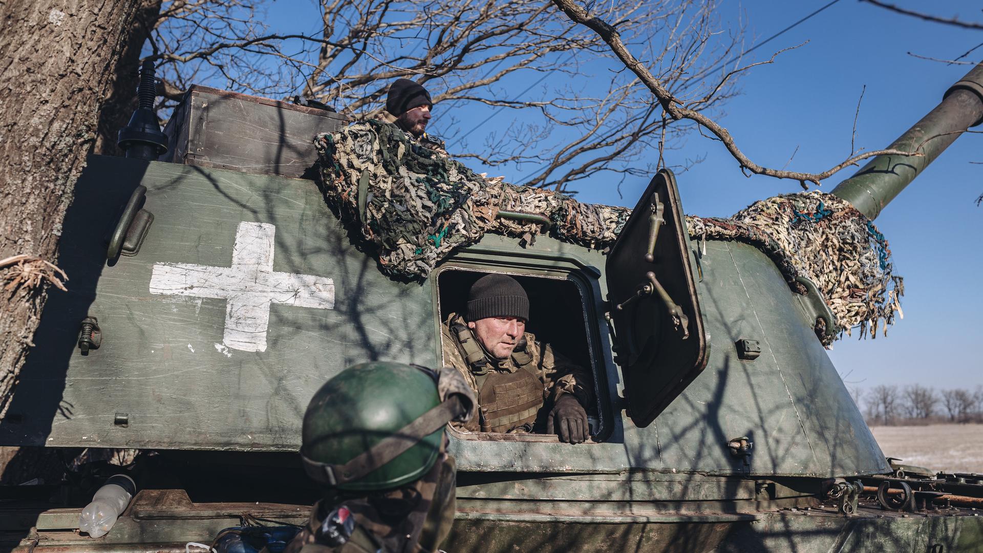 Ein ukrainischer Soldat schaut während des russisch-ukrainischen Kriegs an der Bakhmut-Frontlinie in Donezk aus einem Panzer