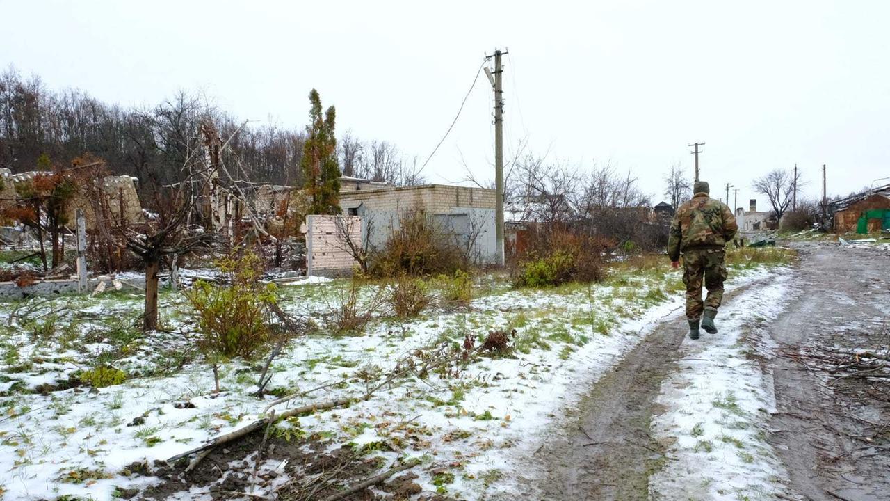 In einem Dorf liegt Schnee, ein Soldat läuft über den Weg. In einem Dorf liegt Schnee, ein Soldat läuft über den Weg.