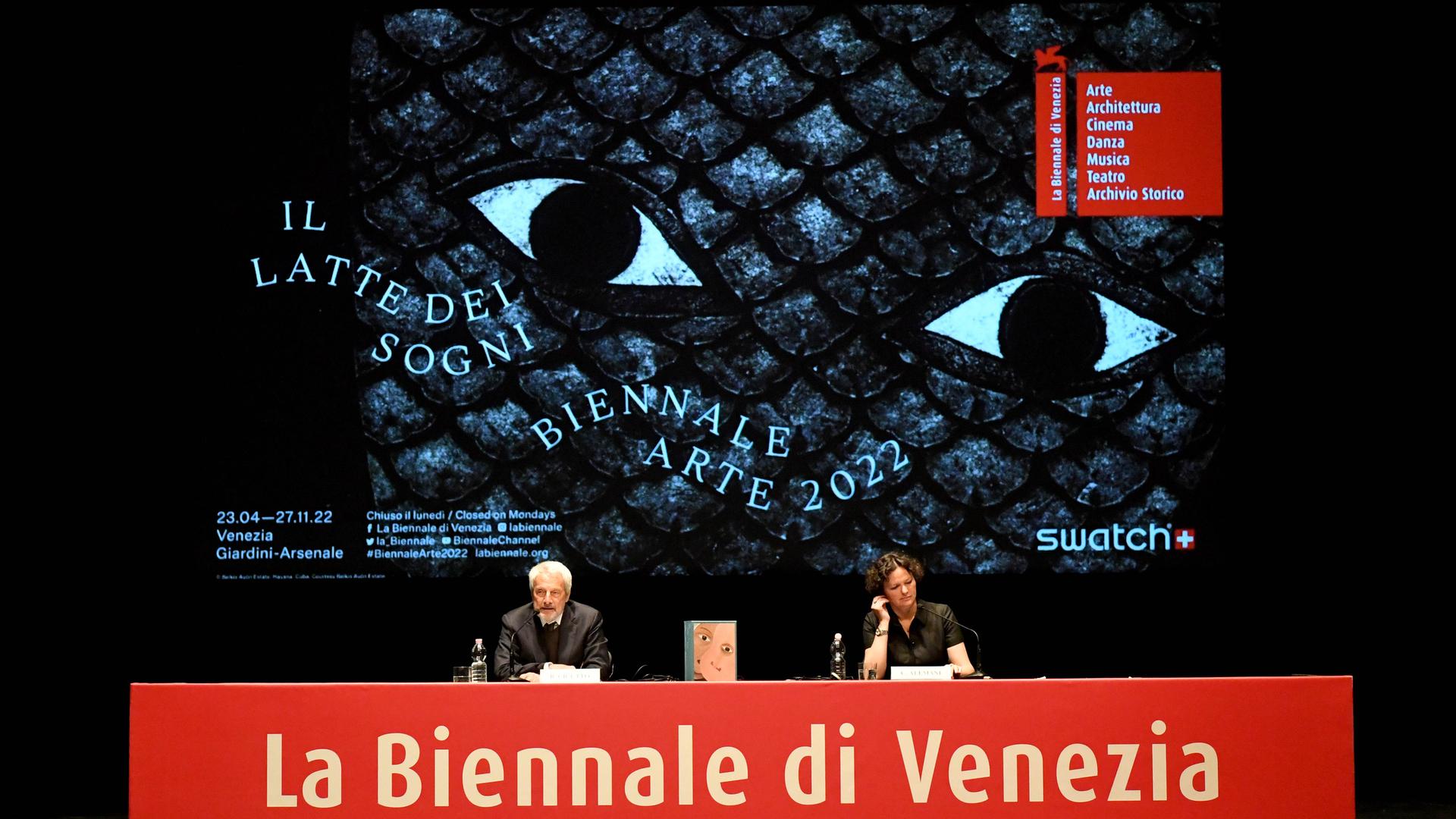 Auf dem Podium bei der Pressekonferenz der 59. Kunstbiennale Venedig sitzen Biennale-Präsident Roberto Cicutto und Kuratorin Cecilia Alemani vor einem großen Biennale-Plakat Auf dem Podium bei der Pressekonferenz der 59. Kunstbiennale Venedig sitzen Biennale-Präsident Roberto Cicutto und Kuratorin Cecilia Alemani vor einem großen Biennale-Plakat
