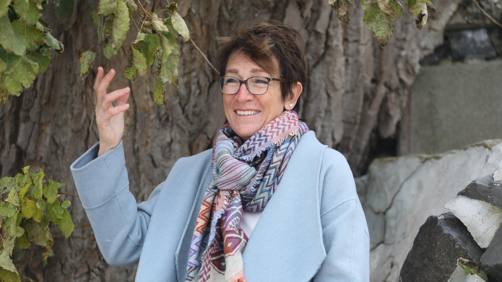 Pflegemutter Susanne Mohnsen. Eine Frau mit kurzen Haaren und Brille hat einen Mantel an und steht im Freien. Pflegemutter Susanne Mohnsen. Eine Frau mit kurzen Haaren und Brille hat einen Mantel an und steht im Freien.