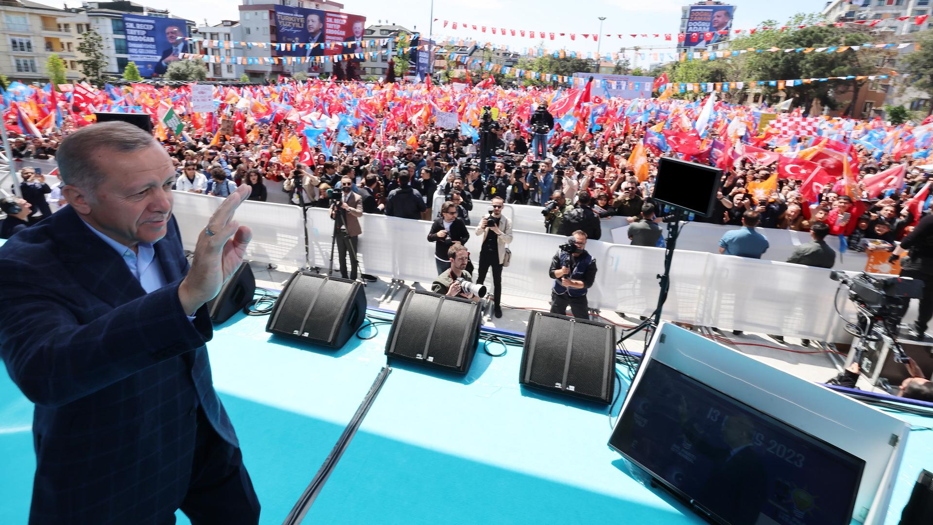 Der türkische Präsident Recep Tayyip Erdogan läuft bei einer Wahlkampfveranstaltung vor Beginn der Präsidentschaftswahlen in der Türkei über eine Bühne und winkt. 