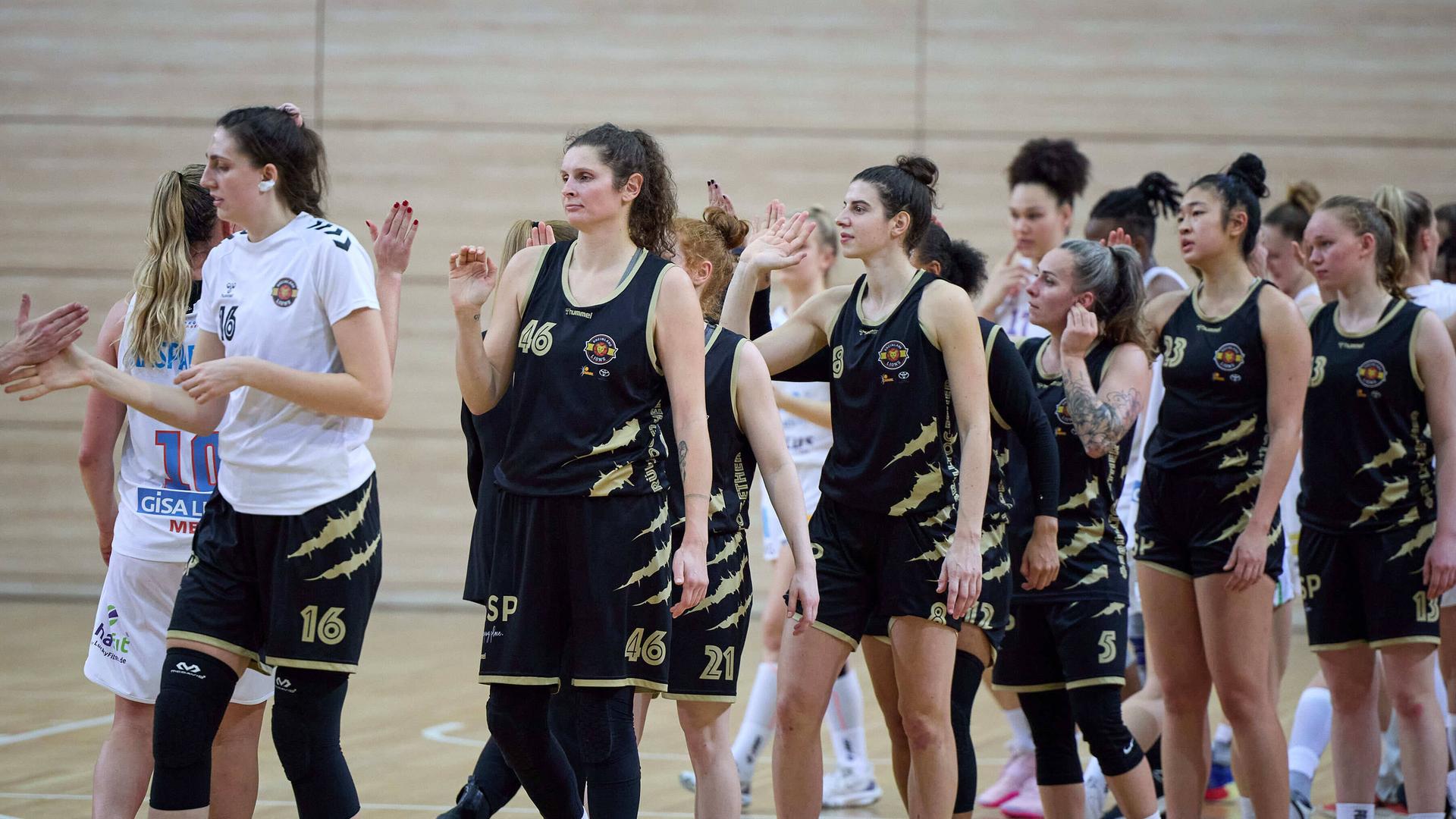 Die Rheinland Lions (in schwarz) klatschen nach einem Meisterschaftsspiel der DBBL mit den Gisa Lions ab. Die Rheinland Lions (in schwarz) klatschen nach einem Meisterschaftsspiel der DBBL mit den Gisa Lions ab.