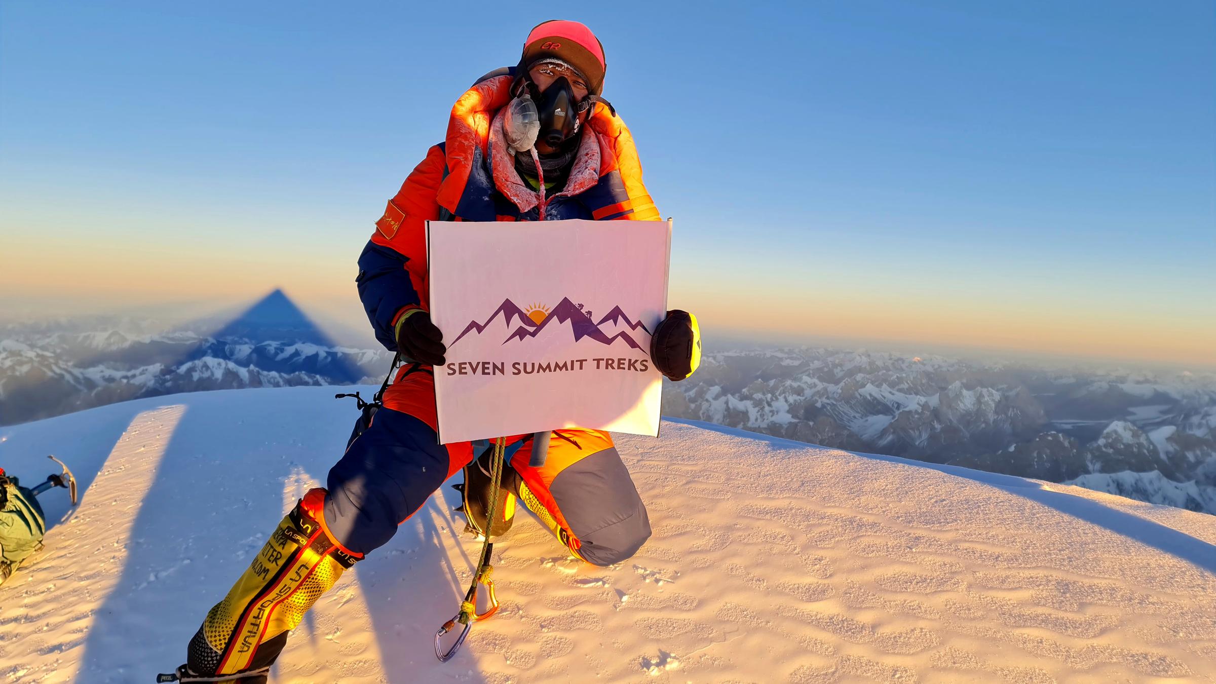 Ein Bergsteiger auf einem schneebedeckten Gipfel hält ein Plakat mit de...</p>

                        <a href=
