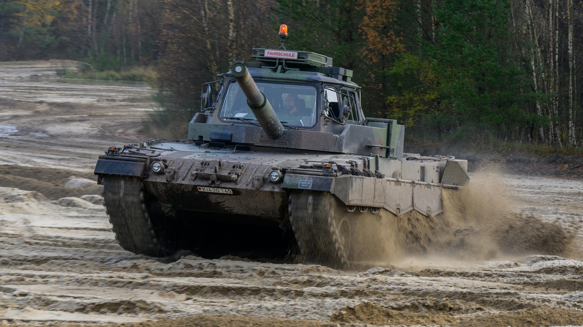 Ein Soldat fährt einen Leopard-II-Fahrtrainingspanzer Ein Soldat fährt einen Leopard-II-Fahrtrainingspanzer