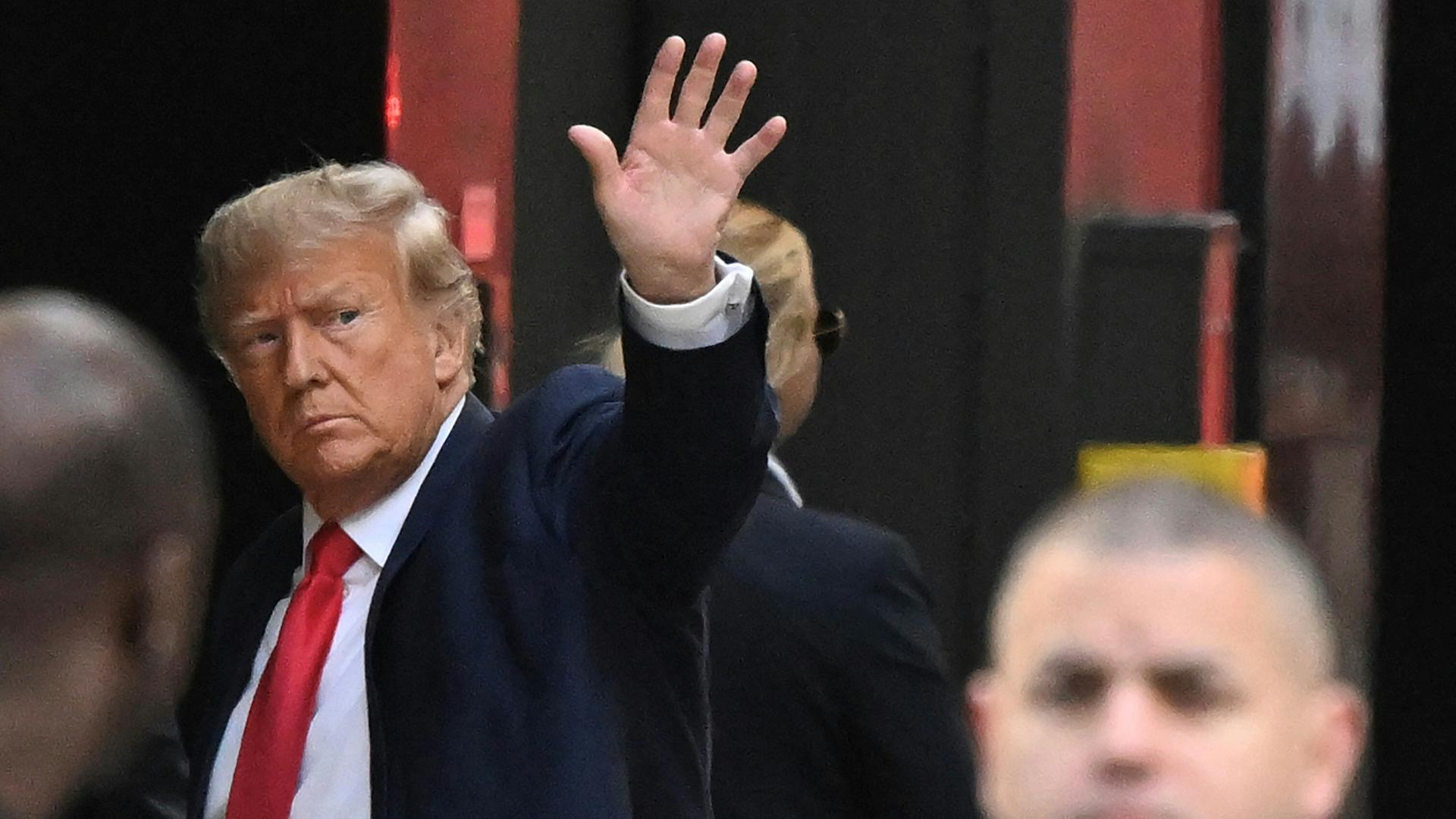 Former US President Donald Trump waves as he arrives at Trump Tower in New York on April 3, 2023. - Trump arrived in New York where he will surrender to unprecedented criminal charges, taking America into uncharted and potentially volatile territory as he seeks to regain the presidency. The 76-year-old Republican, the first US president ever to be criminally indicted, will be formally charged on April 4, 2023 over hush money paid to a porn star during the 2016 election campaign. (Photo by Ed JONES / AFP) / ALTERNATE CROP Former US President Donald Trump waves as he arrives at Trump Tower in New York on April 3, 2023. - Trump arrived in New York where he will surrender to unprecedented criminal charges, taking America into uncharted and potentially volatile territory as he seeks to regain the presidency. The 76-year-old Republican, the first US president ever to be criminally indicted, will be formally charged on April 4, 2023 over hush money paid to a porn star during the 2016 election campaign. (Photo by Ed JONES / AFP) / ALTERNATE CROP